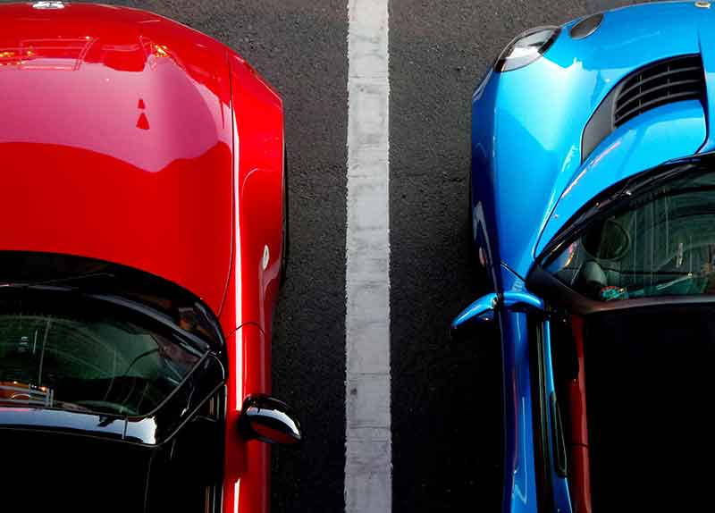 top down view of a red and blue car side-by-side